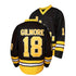 Black hockey jersey with yellow lettering and numbering on a white background